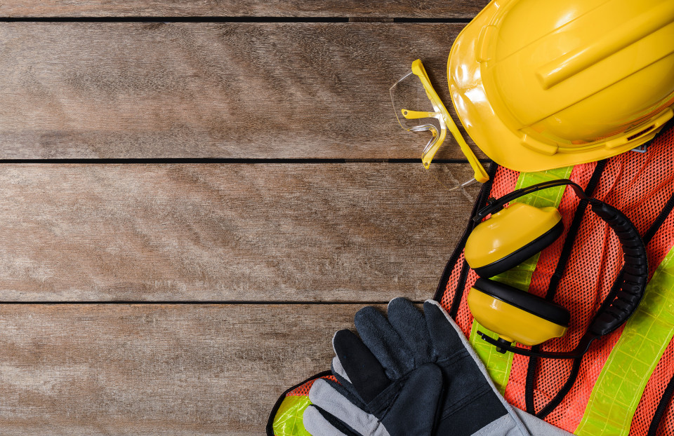 Historic image of construction workers wearing safety helmets while building a bridge