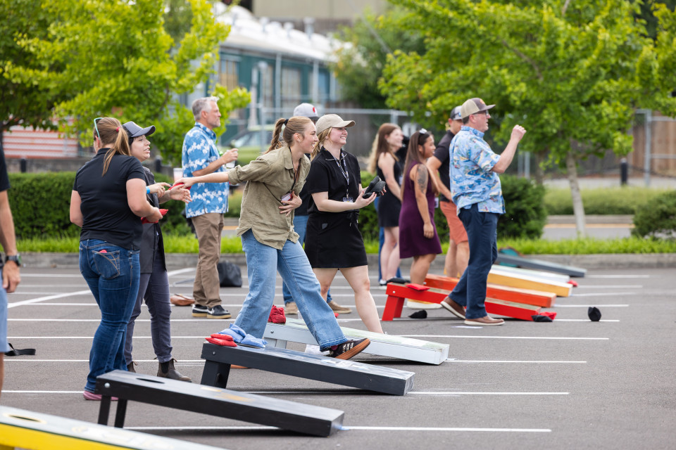 Cornhole tournament participants play in their matches.