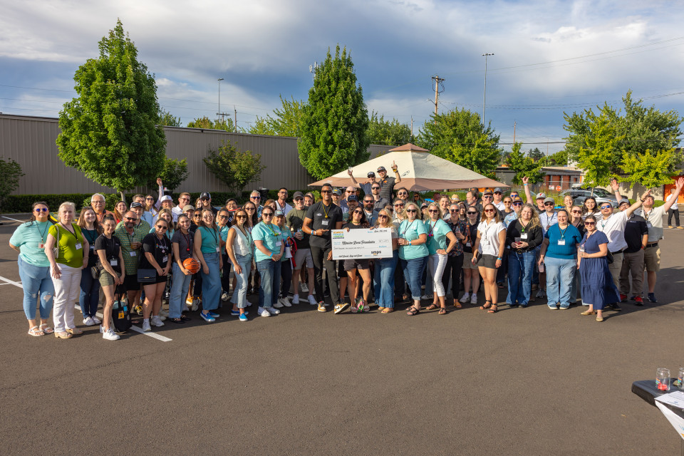 Tournament attendees pose with donation check.